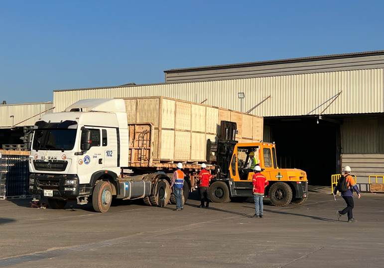 Loading crated cargo onto a truck at a warehouse, iSolution Logistics
