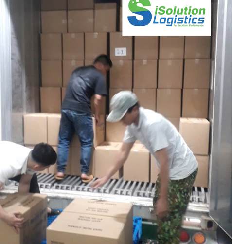 Workers loading cartons into a reefer container, iSolution Logistics