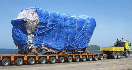 Oversized project cargo covered with tarpaulin on a multi-axle platform trailer